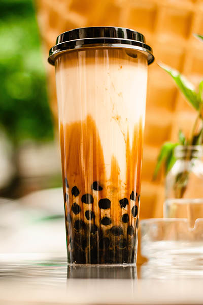 Tall glass of oolong milk tea.