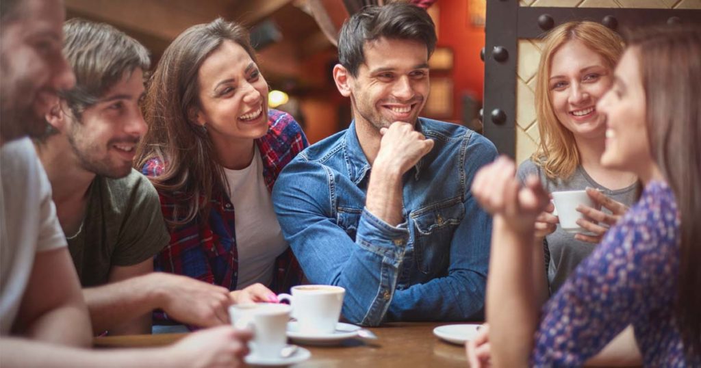 happy people socializing drinking coffee